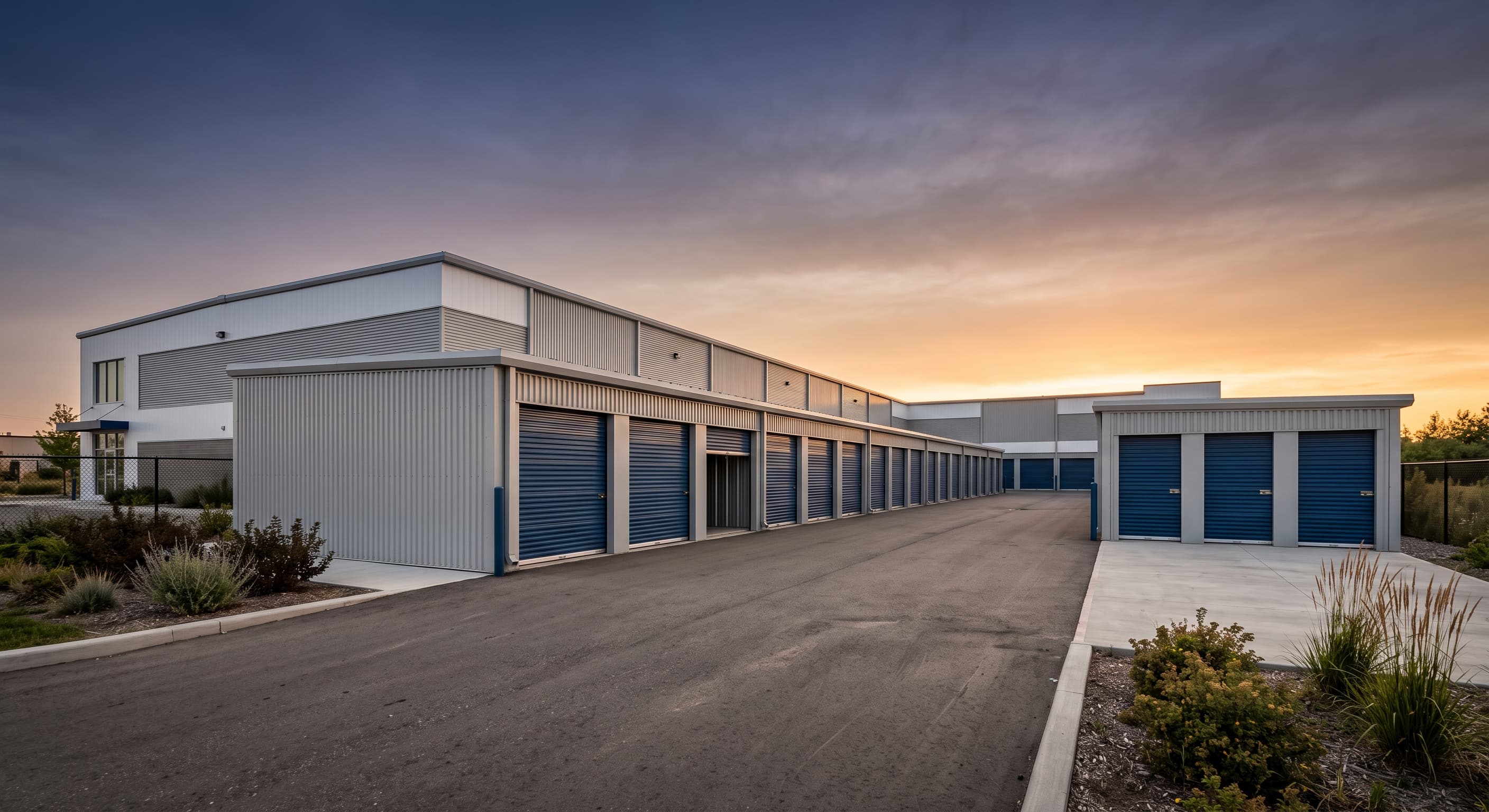 Exterior of a modern self storage facility with drive-up units at golden hour